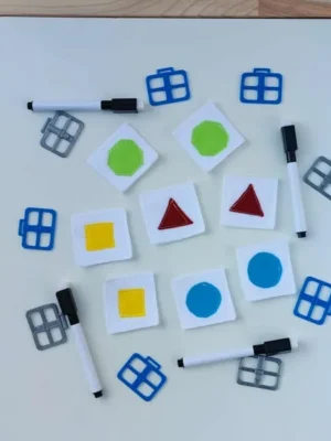 Cartes géométriques en feutrine colorée utilisées pour une activité sensorielle Montessori