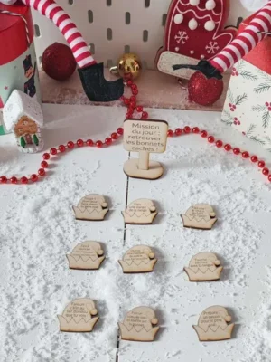 Jeu en bois Mission du jour retrouver les bonnets cachés présenté dans un décor de Noël enneigé avec lutins farceurs et accessoires festifs