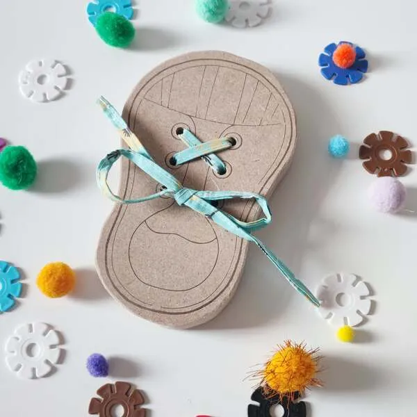 Gros plan sur carte de laçage en bois pour enfant avec lacet, activité de motricité fine et coordination