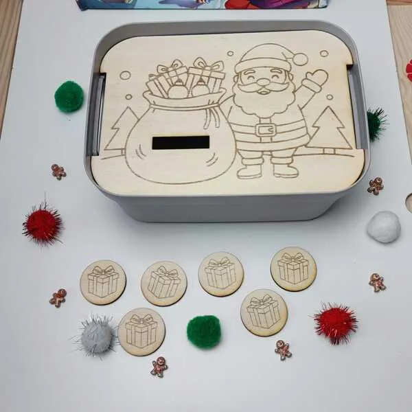 Boîte de tri de Noël avec couvercle gravé représentant le Père Noël et un sac rempli de cadeaux, accompagnée de jetons en bois illustrés de paquets.