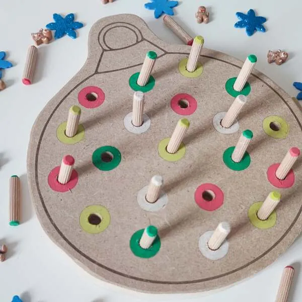 Zoom sur plateau de motricité fine boule de Noël en bois avec pics colorés à insérer pour enfant