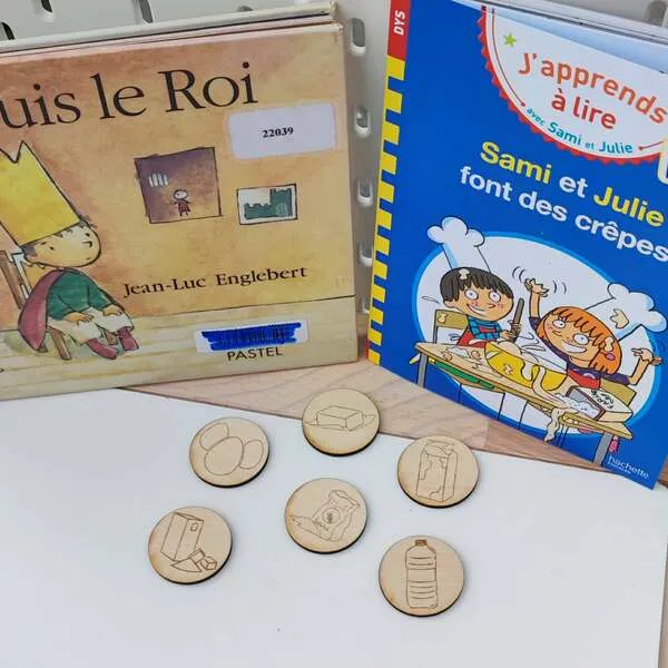 Jetons ingrédients en bois pour activité crêpes enfant avec livres jeunesse en arrière-plan