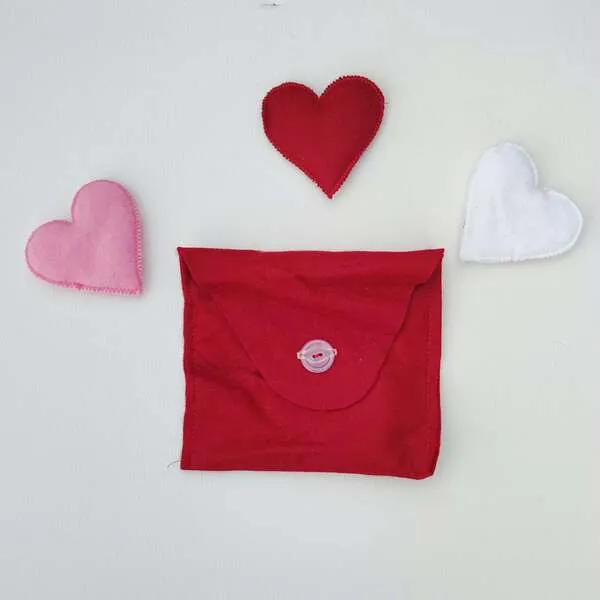 Pochette en feutrine rouge avec cœurs en tissu pour activité sensorielle enfant thème Saint-Valentin