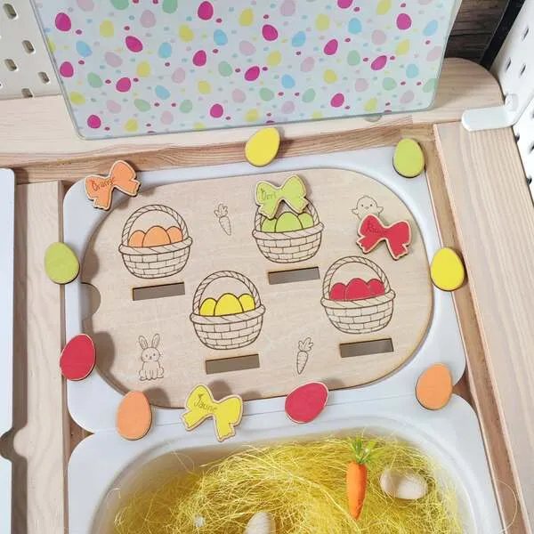 Insert en bois tri des couleurs thème Pâques avec paniers d’œufs et jetons colorés.