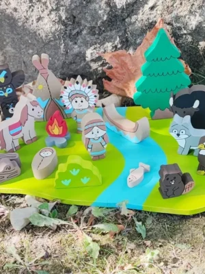 Mini monde en bois sur le thème des Indiens d'Amérique avec personnages, animaux, tipi, canoë, feu de camp, rivière et éléments de nature fabriqués à la main.