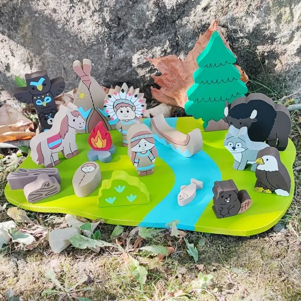 Mini monde en bois sur le thème des Indiens d'Amérique avec personnages, animaux, tipi, canoë, feu de camp, rivière et éléments de nature fabriqués à la main.