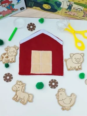 Poche en feutrine rouge en forme de grange avec quatre figurines en bois (vache, cochon, cheval et poule) à cacher et retrouver.